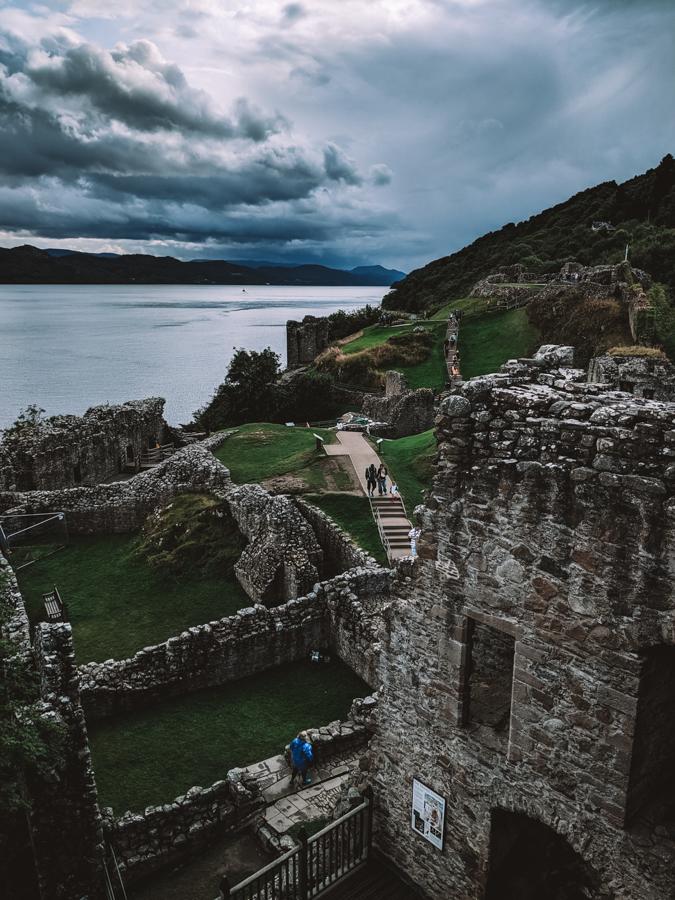ruins of a castle in europe with tourists exploring
