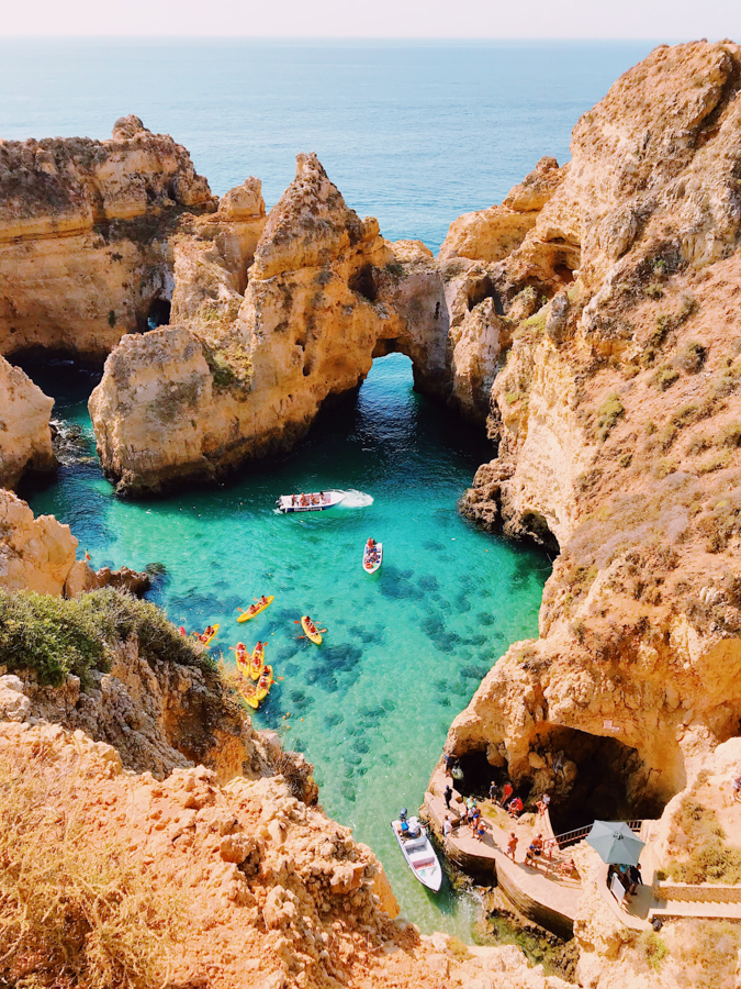 tourists kayaking in the clear waters of portugal