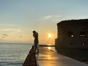 silhouette of a woman on adventures for all trip on a dock