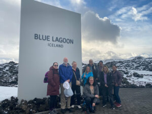 adventures for all standing in front of a blue lagoon iceland sign
