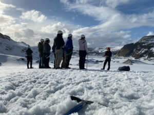 adventures for all group listening to hiking guide while standing in snow
