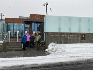 adventures for all group members posing next to the united states embassy building in iceland