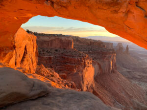 stone arches of the utah big 5 illuminate by a sunset