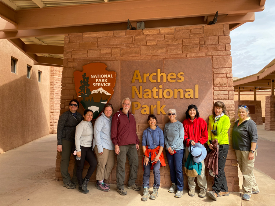 adventures for all group standing in front of the Arches National Park sign