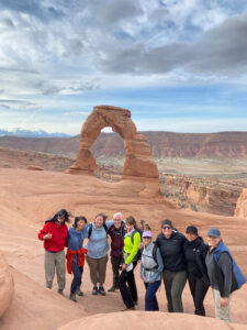 adventures for all group smiling in front of Utah Big 5 stone archway