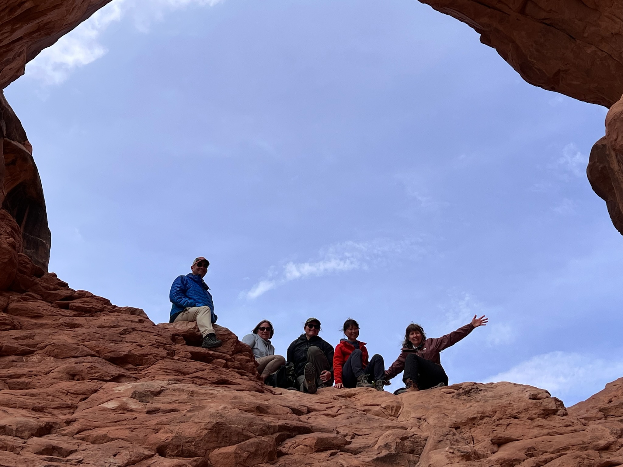adventures for all group posing on arched rocks in utah