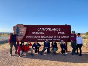 adventures for all group standing in front of the canyonlands national park sign in utah