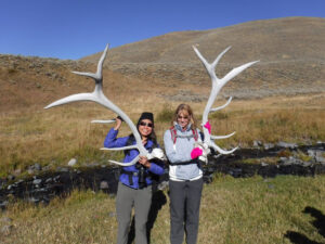 adventures for all members holding two large elk antlers
