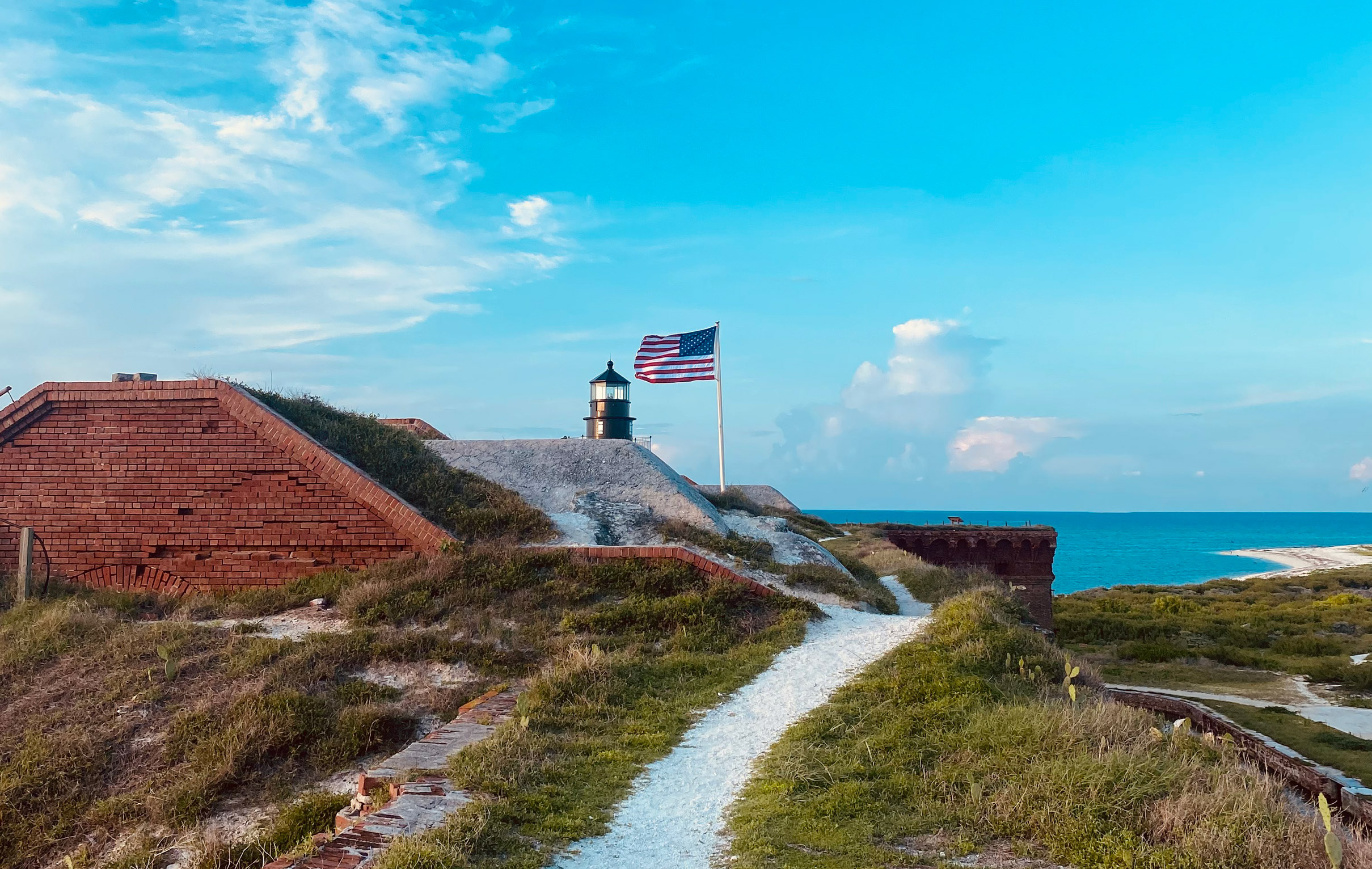 american flag waving in the wind by fort jefferson in the dry tortugas