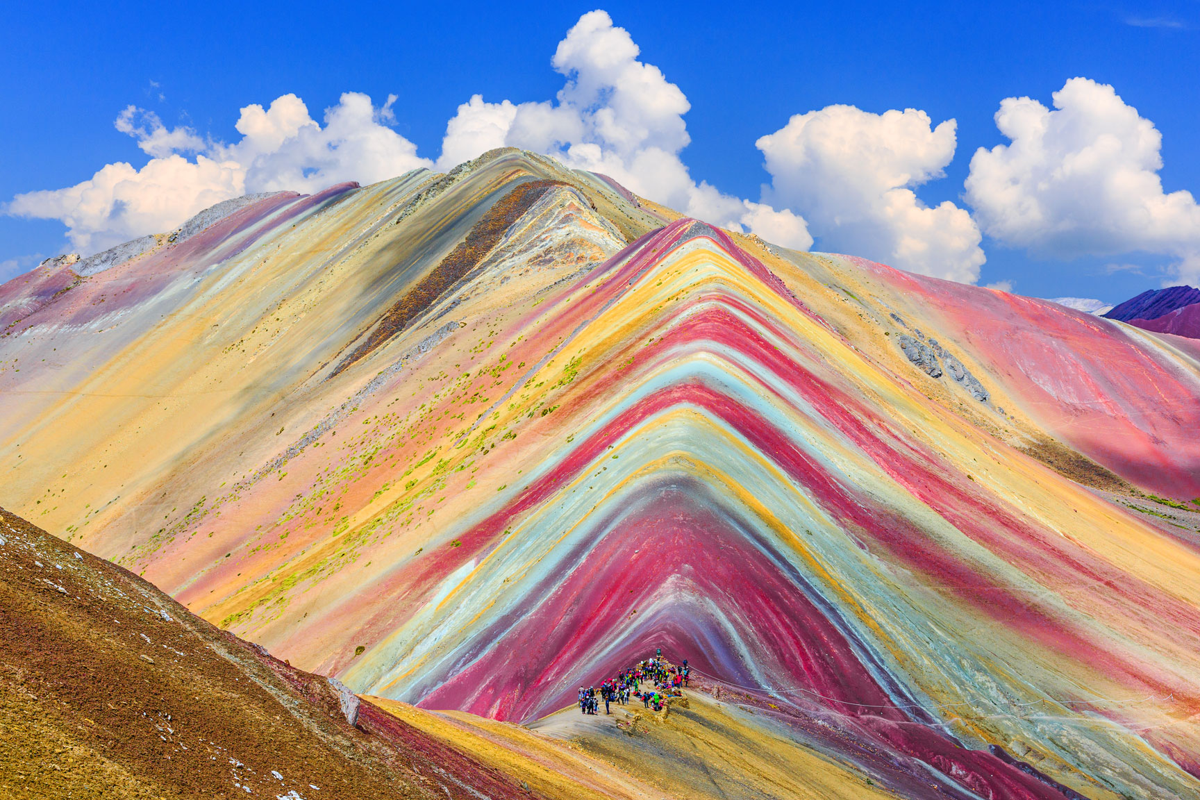 hikers visiting the rainbow mountains in peru