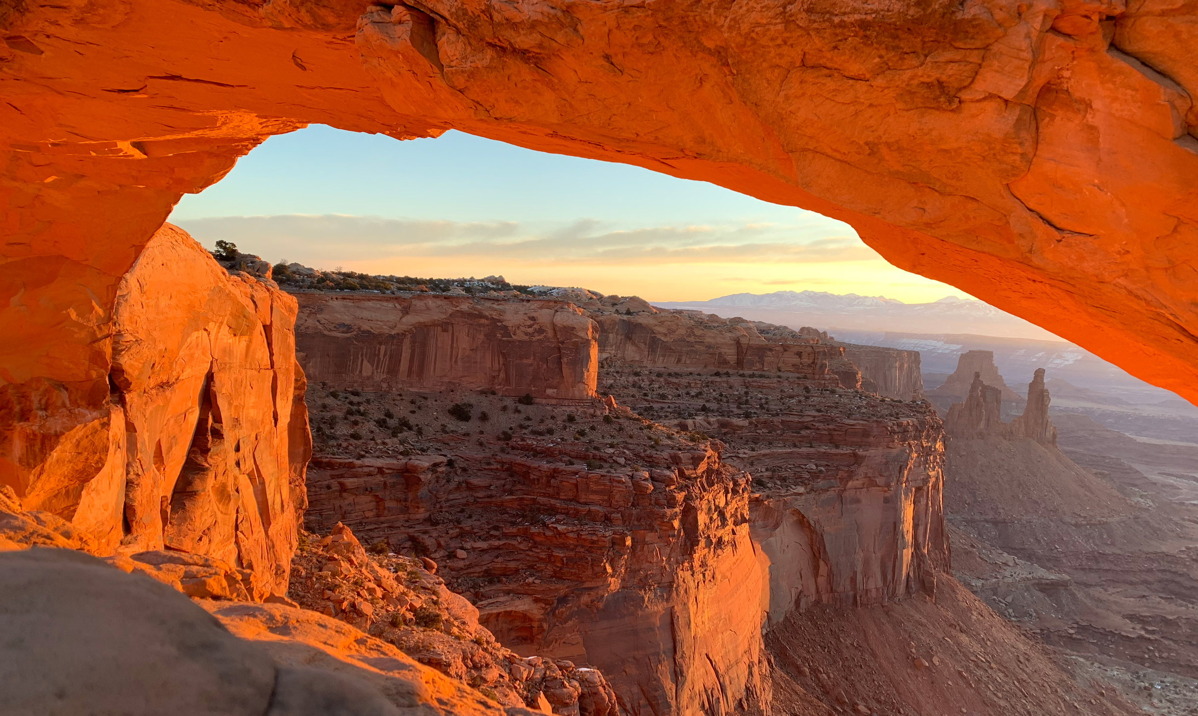 view of the stone arches overlooking a canyon at sunset