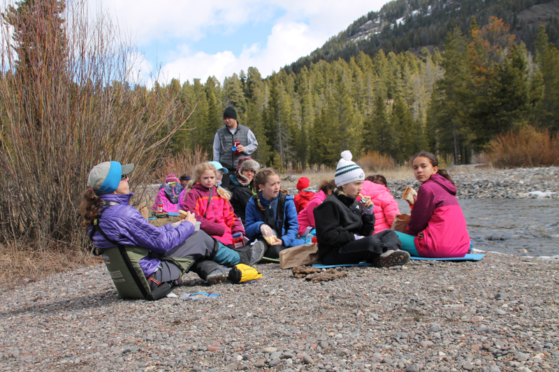 youth educational adventures group enjoying lunch on a stone covered beach