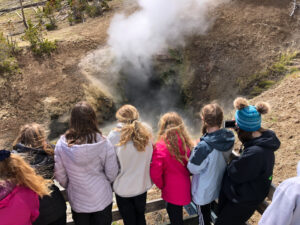 youth educational adventures group viewing a geyser