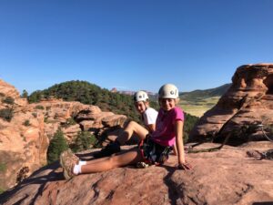 two young youth educational adventurers posing on the red rocks of zion national park